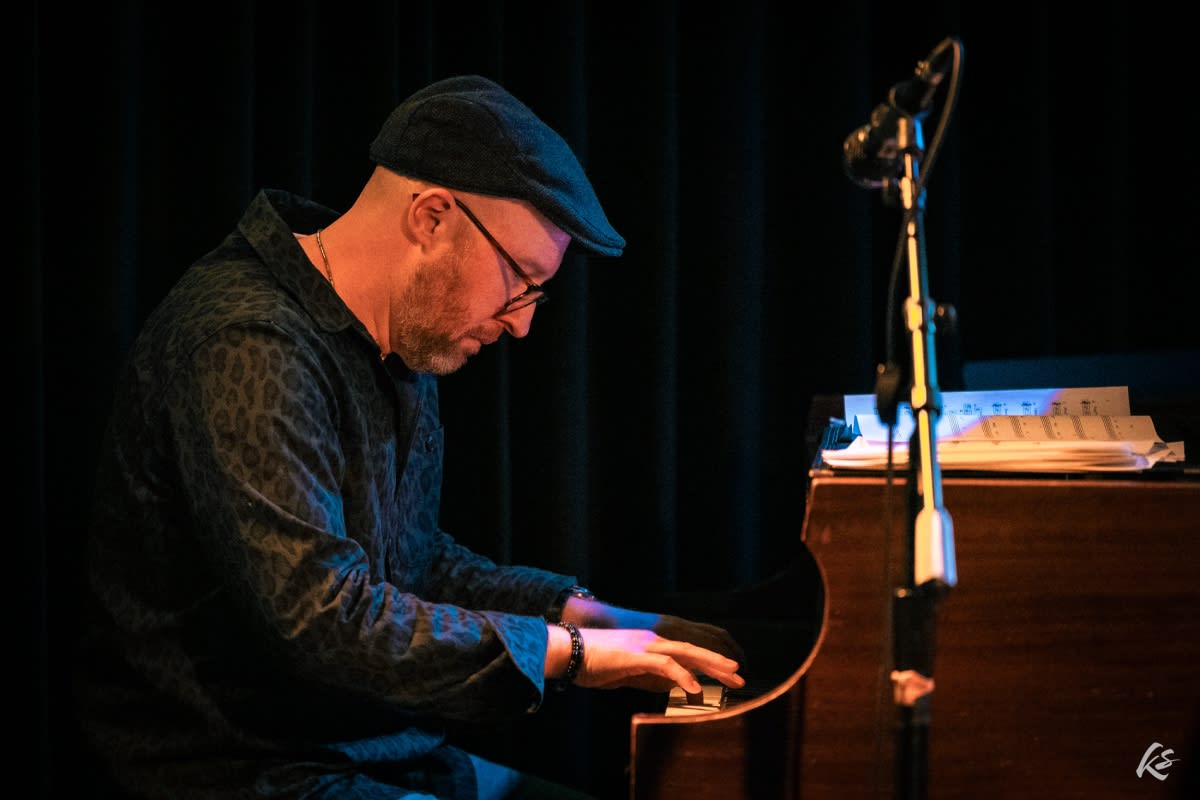 adam playing the piano