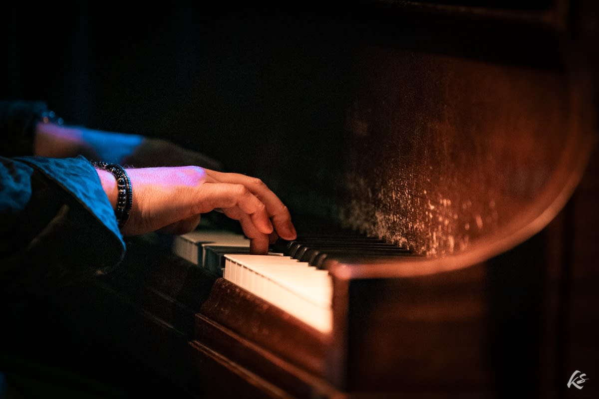 closeup of adam's hands on the piano